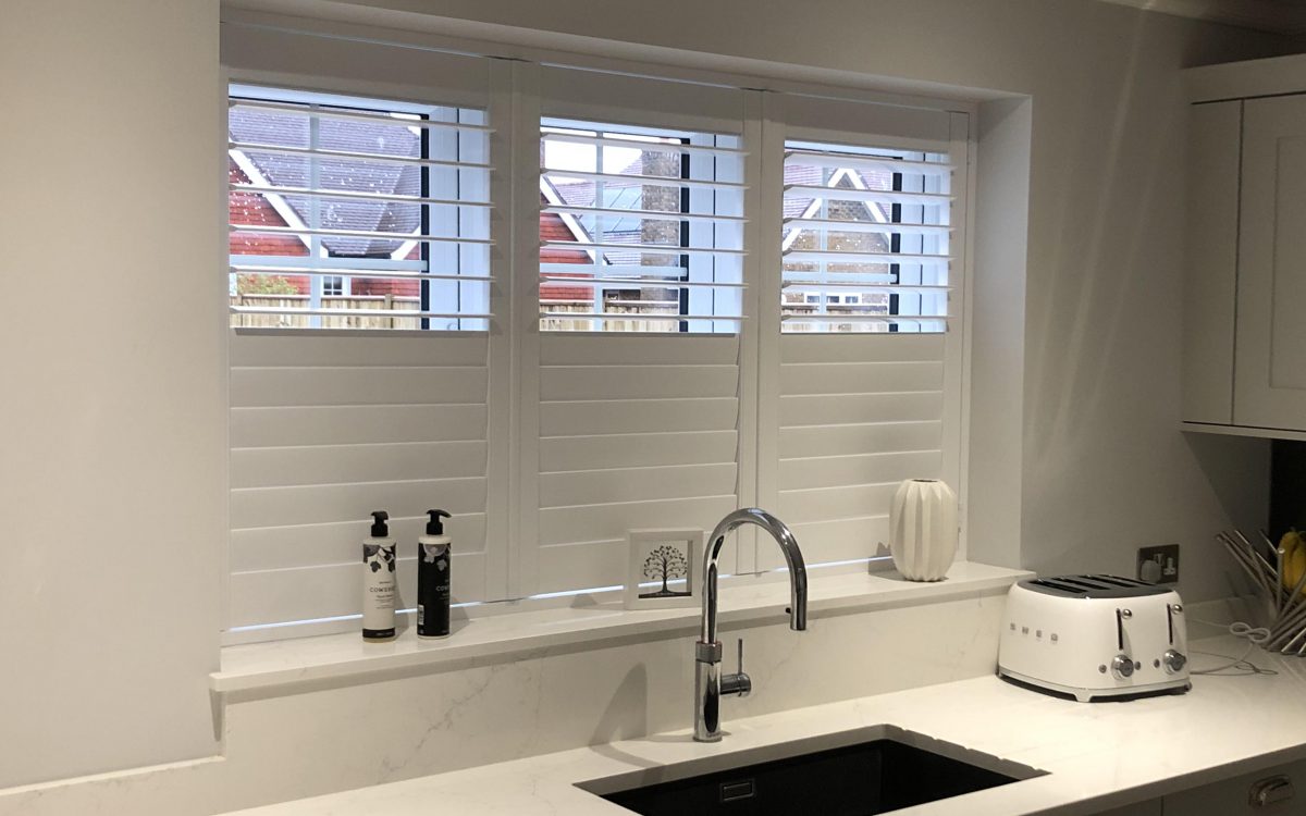 Full Height Shutters in white kitchen by Woodstock Shutter Company